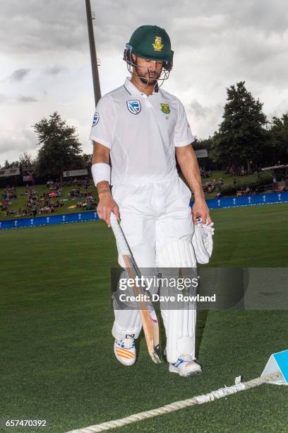 Jean-Paul Duminy of South Africa leaves the field after being caught by Jeetan Patel and bowled by Matt Henry of New Zealand during day one of the...