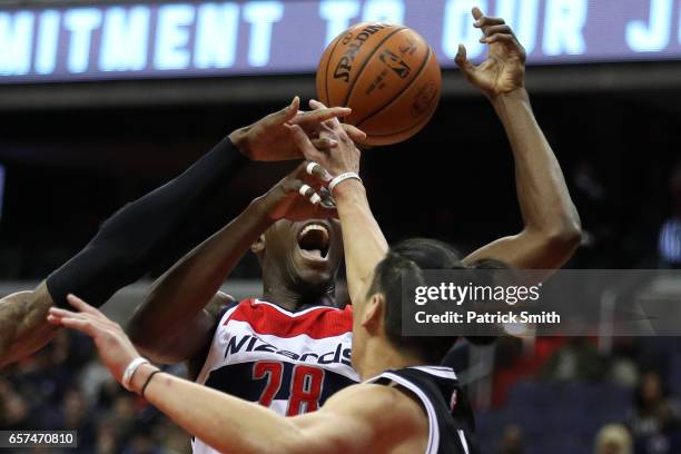 Ian Mahinmi of the Washington Wizards is fouled by Jeremy Lin of the Brooklyn Nets during the first half at Verizon Center on March 24, 2017 in...