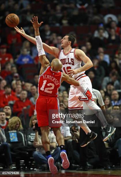 Paul Zipser of the Chicago Bulls puts up a shot over Gerald Henderson of the Philadelphia 76ers at the United Center on March 24, 2017 in Chicago,...