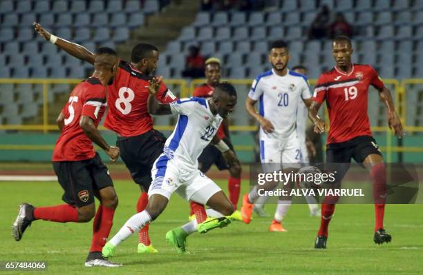 Panama's forward Abdiel Arroyo vies for the ball with Trinidad and Tobago's midfielder Khaleem Hyland and Trinidad and Tobago's midfielder Kevan...