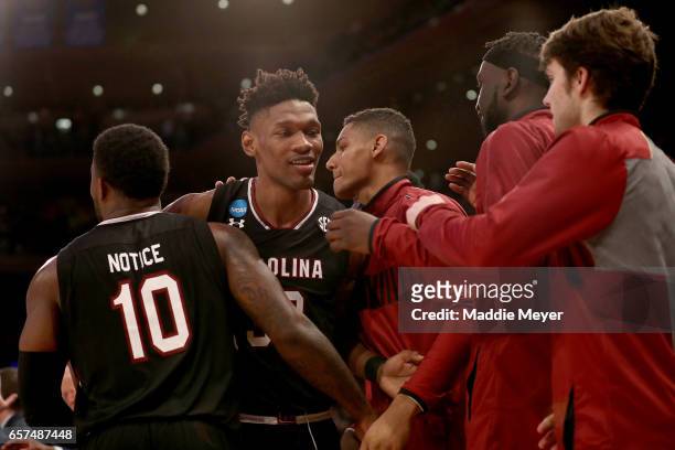 Chris Silva of the South Carolina Gamecocks celebrates with his teammates after being taken out of the game late in the second half against the...