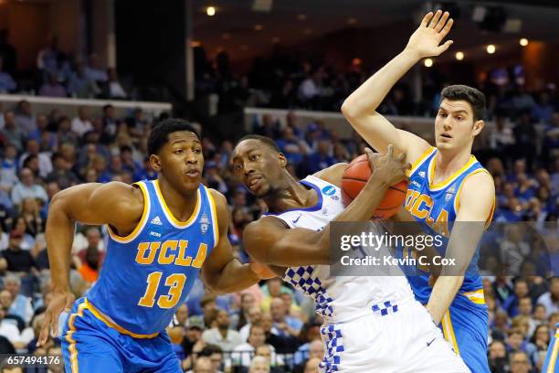 Edrice Adebayo of the Kentucky Wildcats handles the ball against Ike Anigbogu and Gyorgy Goloman of the UCLA Bruins in the first half during the 2017...