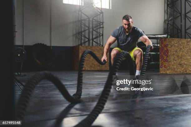 strengthen and sweat - battle rope stock pictures, royalty-free photos & images