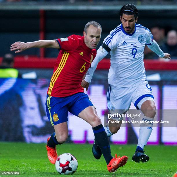 Andres Iniesta of Spain duels for the ball with Lior Refaelov of Israel during the FIFA 2018 World Cup Qualifier between Spain and Israel at Estadio...