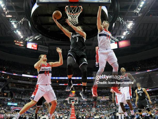 Brooklyn Nets guard Jeremy Lin scores in the first half against Washington Wizards forward Jason Smith on March 24 at the Verizon Center in...