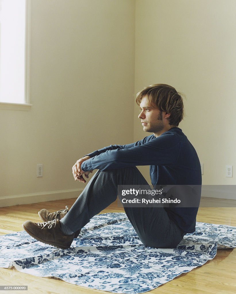 Man Sitting on Floor