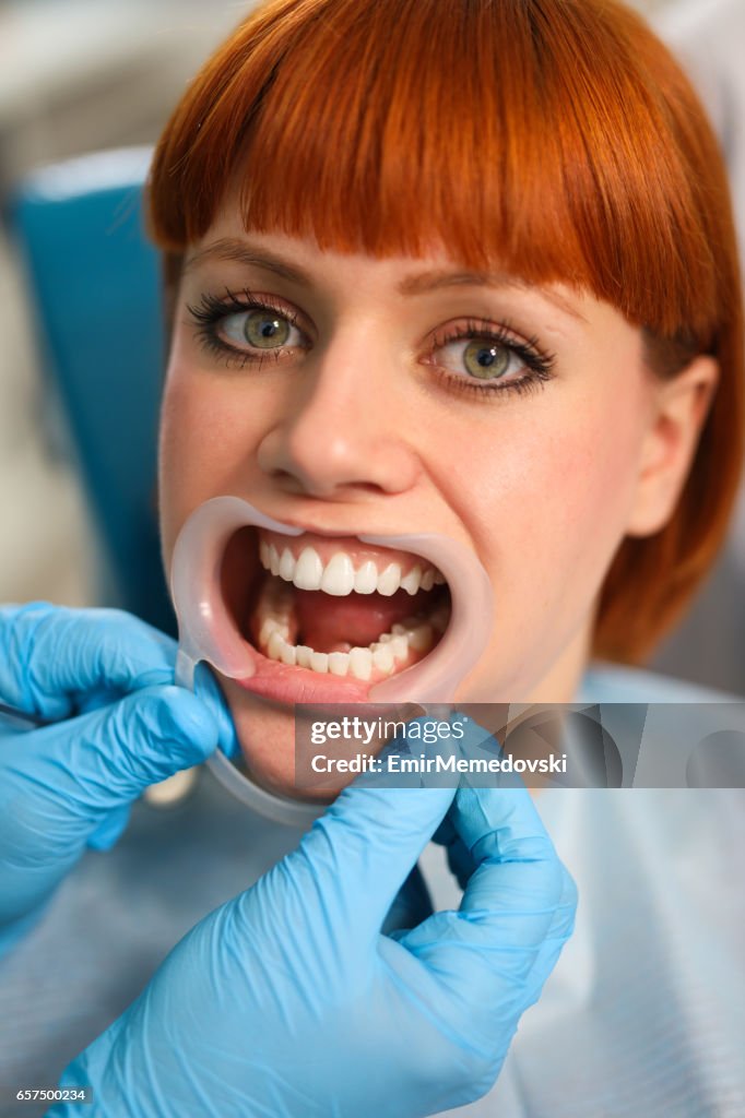 Young woman at dentist's office for routine checkup.