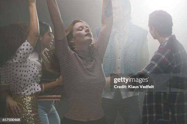 group of happy people dancing in room with backlight - white people dancing photos et images de collection