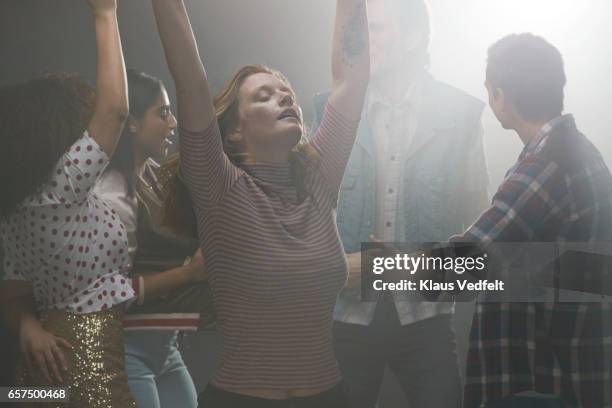 group of happy people dancing in room with backlight - dance floor stock pictures, royalty-free photos & images