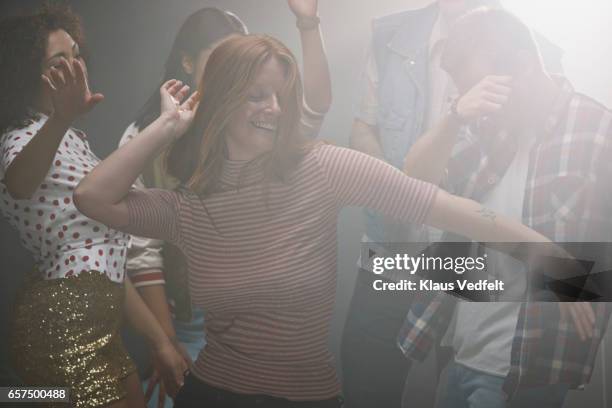 group of happy people dancing in room with backlight - 20 years old dancing stock pictures, royalty-free photos & images