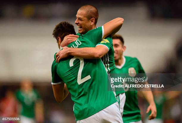 Mexico's forward Javier Hernandez celebrates with teammate Nestor Araujo after scoring against Costa Rica during their 2018 FIFA World Cup qualifier...