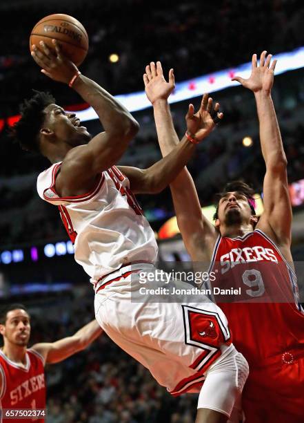 Jimmy Butler of the Chicago Bulls puts up a shot over Dario Saric of the Philadelphia 76ers on his way to a game-high 36 points at the United Center...