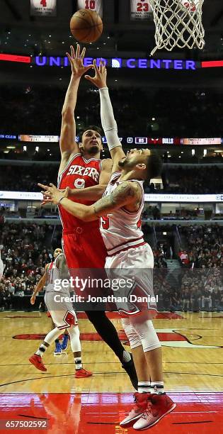Dario Saric of the Philadelphia 76ers shoots over Denzel Valentine of the Chicago Bulls at the United Center on March 24, 2017 in Chicago, Illinois....