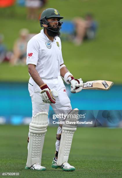 Hashim Amla of South Africa walks after being bowled by Colin de Grandhomme of New Zealand during day one of the Test match between New Zealand and...