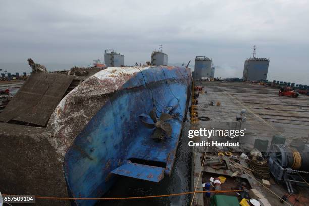 In this handout photo released by the South Korean Maritime Ministry, Workers participate in the salvage operation of the Sewol ferry in waters off...