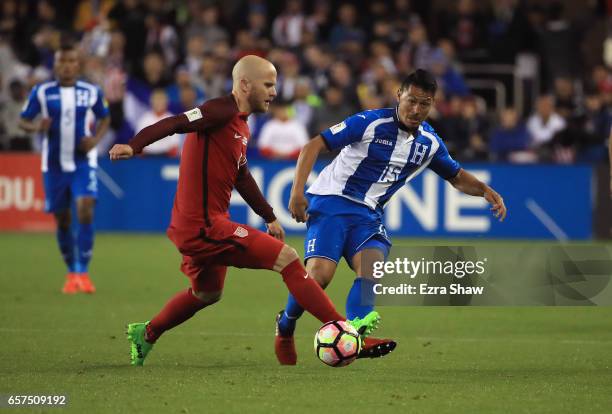 Roger Espinoza of Honduras passes the ball pass Michael Bradley of the United States during their FIFA 2018 World Cup Qualifier at Avaya Stadium on...