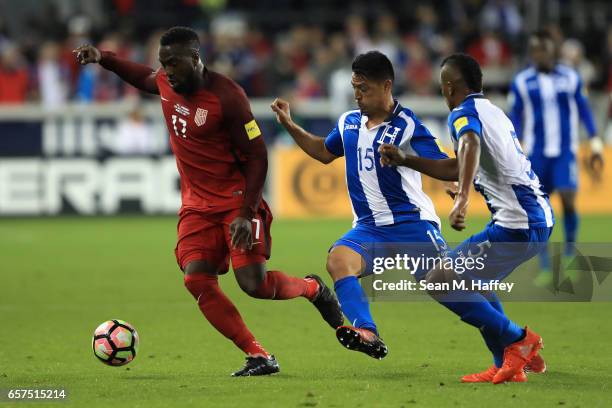 Josy Altidore of the United States dribbles past Roger Espinoza and Ever Alvaroado of Honduras during their FIFA 2018 World Cup Qualifier at Avaya...
