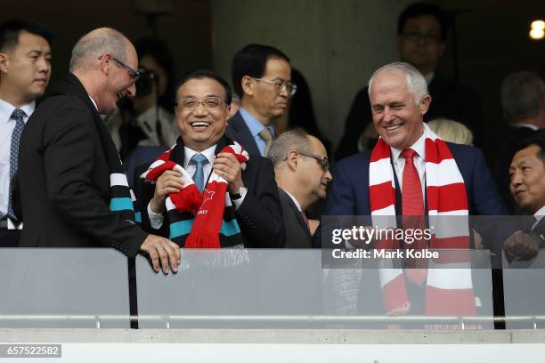 Television host David Koch, Chinese Premier Li Keqiang and Australia's Prime Minister Malcolm Turnbull share a joke before kick-off during the round...