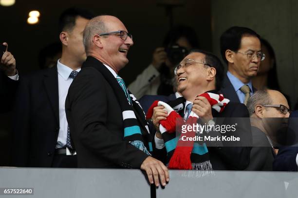 Television host David Koch and Chinese Premier Li Keqiang share a joke before kick-off during the round one AFL match between the Sydney Swans and...