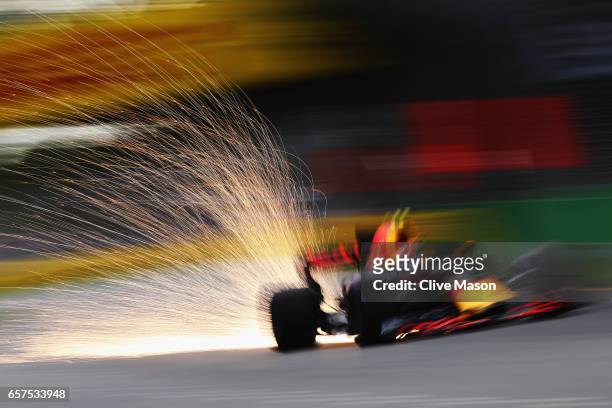 Sparks fly behind Max Verstappen of the Netherlands driving the Red Bull Racing Red Bull-TAG Heuer RB13 TAG Heuer on track during qualifying for the...
