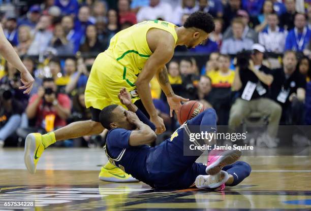 Muhammad-Ali Abdur-Rahkman of the Michigan Wolverines reacts after being hit by Tyler Dorsey of the Oregon Ducks during the 2017 NCAA Men's...