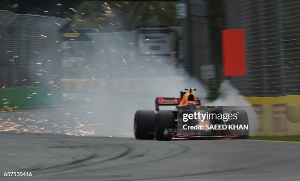 Sparks fly and smoke comes from the car as Red Bull's Australian driver Max Verstappen during the qualifying session for the Formula One Australian...