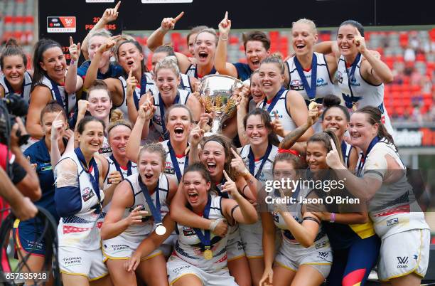 Crows players celebrate during the AFL Women's Grand Final between the Brisbane Lions and the Adelaide Crows on March 25, 2017 in Gold Coast,...