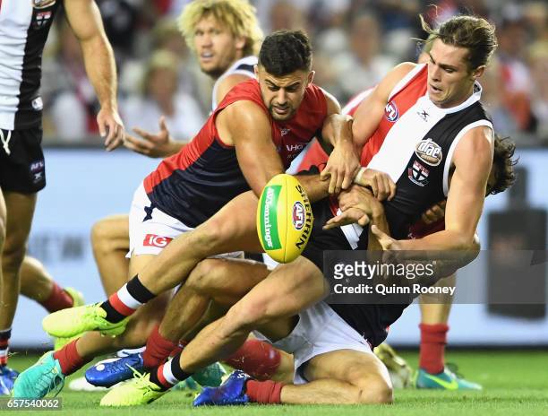 Jack Steele of the Saintsis tackled by Christian Salem and Jeff Garlett of the Demons during the round one AFL match between the St Kilda Saints and...