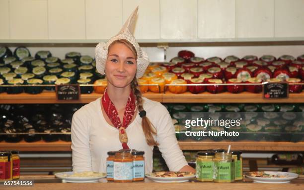 Dutch woman selling cheese at a small shop in the town of Zaanse Schans, Holland, Netherlands, Europe.
