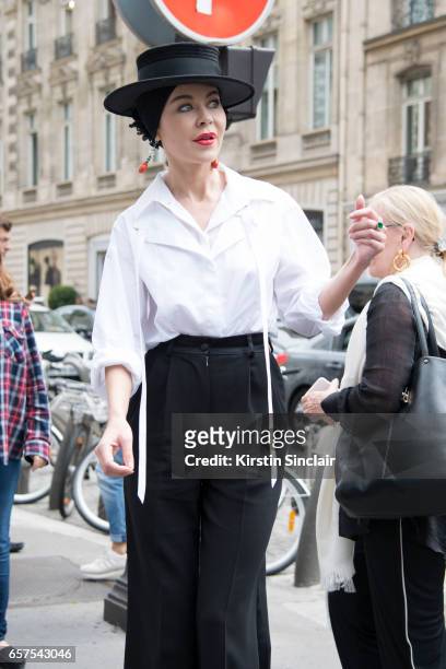 Fashion designer Ulyana Sergeenko wears a Chanel blouse, Dolce & Gabbana trousers and Stephen Jones hat day 2 of Paris Haute Couture Fashion Week...