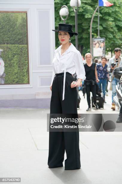 Fashion designer Ulyana Sergeenko wears a Chanel blouse, Dolce & Gabbana trousers and Stephen Jones hat day 2 of Paris Haute Couture Fashion Week...