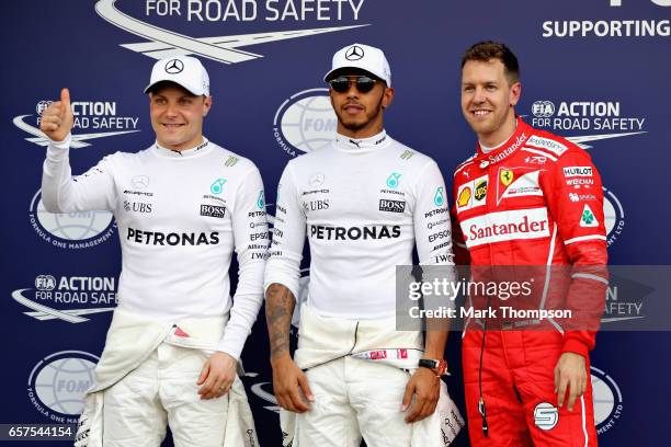 Top three qualifiers Lewis Hamilton of Great Britain and Mercedes GP, Sebastian Vettel of Germany and Ferrari and Valtteri Bottas of Finland and...