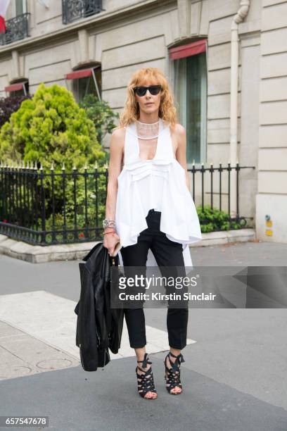 Kabuki store owner and fashion buyer Elina Halimi wears a Toni Maticevski top, Burberry trousers and jacket, Ray Ban sunglasses, Vintage Yves Saint...