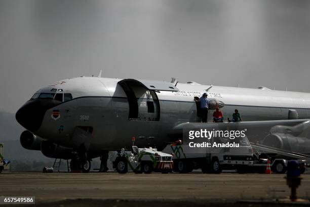 Crew members of a US Air Force Boeing 707 aircraft conduct a ground inspection at Sultan Iskandar Muda Airport in Aceh Besar, Aceh province, on March...