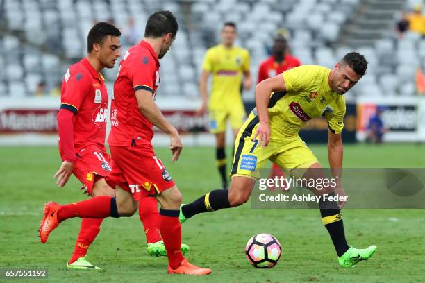 Fabio Ferreira of the Mariners is contested by the Adelaide defence during the round 24 A-League match between Central Coast Mariners and Adelaide...