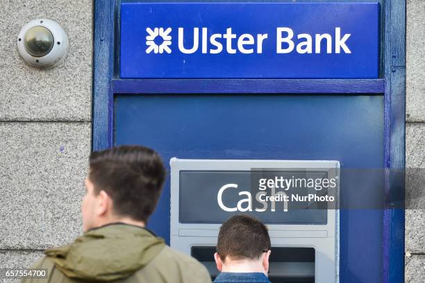 People outside a cash mashine in Dublin's city center. Ulster Bank Chief Executive Gerry Mallon announced that Ulster Bank to close 22 branches in...