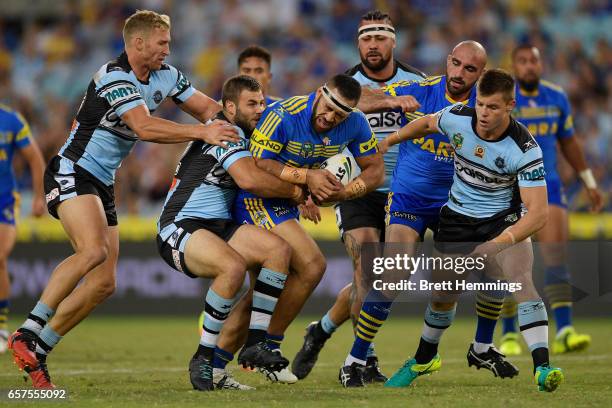 Suaia Matagi of the Eels is tackled during the round four NRL match between the Parramatta Eels and the Cronulla Sharks at ANZ Stadium on March 25,...