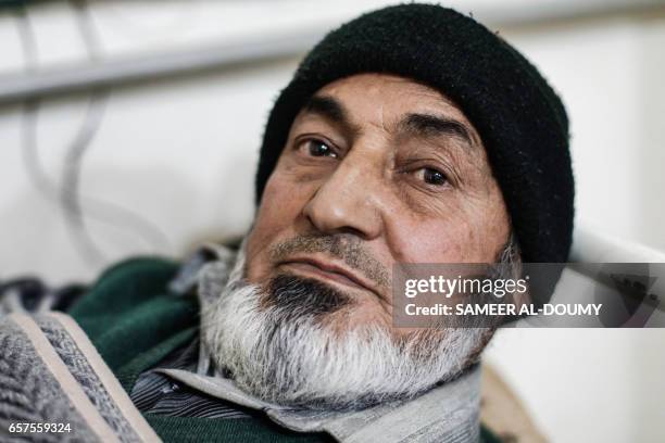 Abu Yaseen, a 56-year-old Syrian who has suffered from renal insufficiency since two years prior, lies on a bed as he receives a dialysis session...