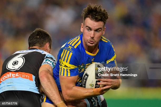 Clinton Gutherson of the Eels is tackled during the round four NRL match between the Parramatta Eels and the Cronulla Sharks at ANZ Stadium on March...