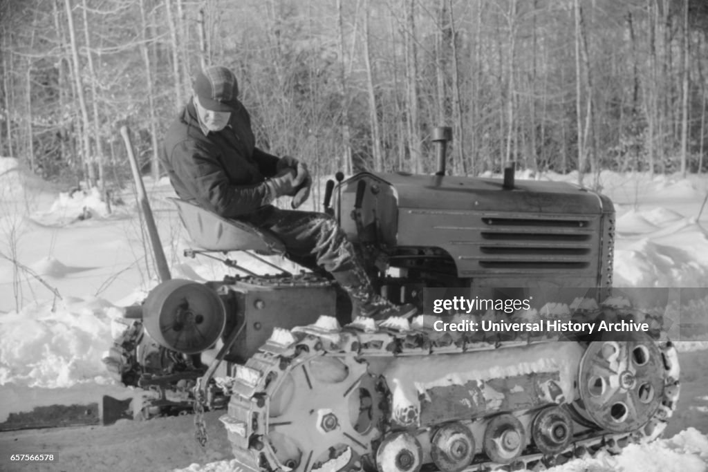 Hauling Timber by Tractor to Road where it is Taken by Truck to Mill, near Barnard, Vermont, March 1940