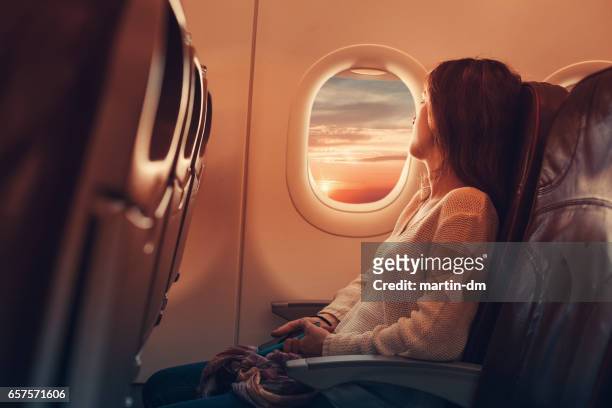 young woman flying to france - window stock pictures, royalty-free photos & images