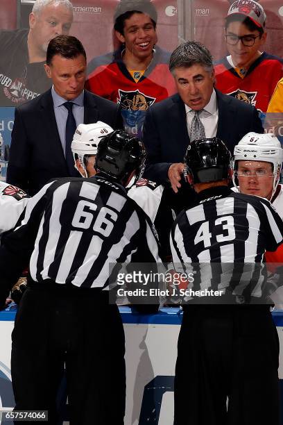 Arizona Coyotes Executive Vice President of Hockey Operations/Head Coach Dave Tippett chats with on ice officials during a break in the action...