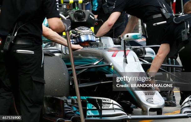 Mercedes' Finnish driver Valtteri Bottas is moved back to the team garage during the qualifying session for the Formula One Australian Grand Prix in...