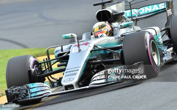 Mercedes' British driver Lewis Hamilton powers through a corner during the qualifying session for the Formula One Australian Grand Prix in Melbourne...