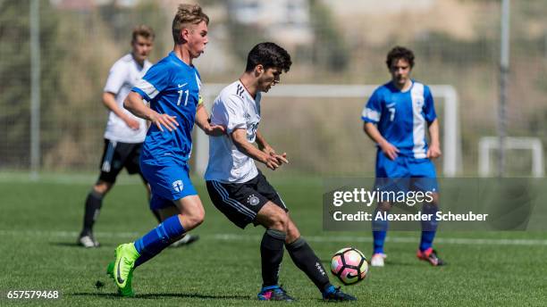 Jyri Kiuru of Finland challenges Elias Abouchabaka of Germany during the UEFA U17 elite round match between Germany and Finland on March 25, 2017 in...