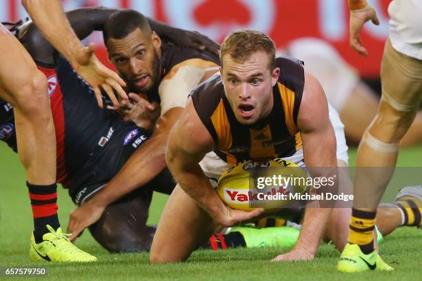 Tom Mitchell of the Hawks gathers the ball during the round one AFL match between the Essendon Bombers and the Hawthorn Hawks at Melbourne Cricket...