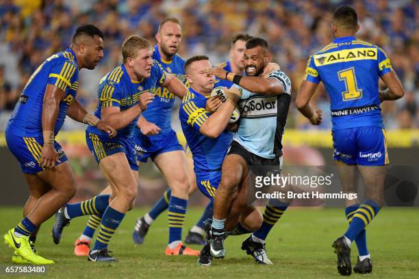 Jayson Bukuya of the Sharks is tackled during the round four NRL match between the Parramatta Eels and the Cronulla Sharks at ANZ Stadium on March...