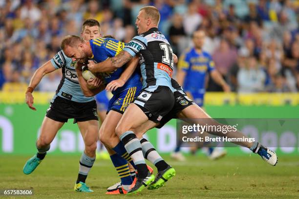 David Gower of the Eels is tackled during the round four NRL match between the Parramatta Eels and the Cronulla Sharks at ANZ Stadium on March 25,...