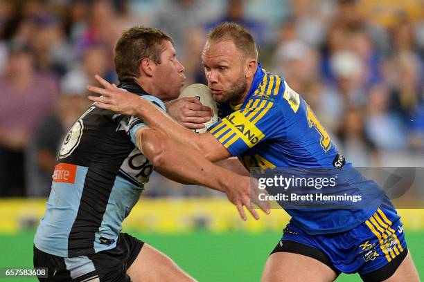 David Gower of the Eels is tackled during the round four NRL match between the Parramatta Eels and the Cronulla Sharks at ANZ Stadium on March 25,...