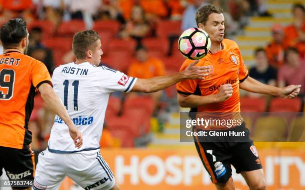 Mitchell Austin of the Victory and Thomas Kristensen of the Roar contest for the ball during the round 24 A-League match between Brisbane Roar and...